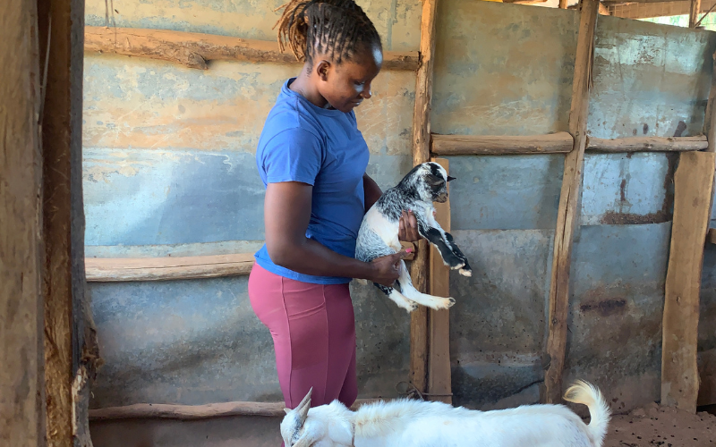 A photo of me holding a newly born kid in our farm